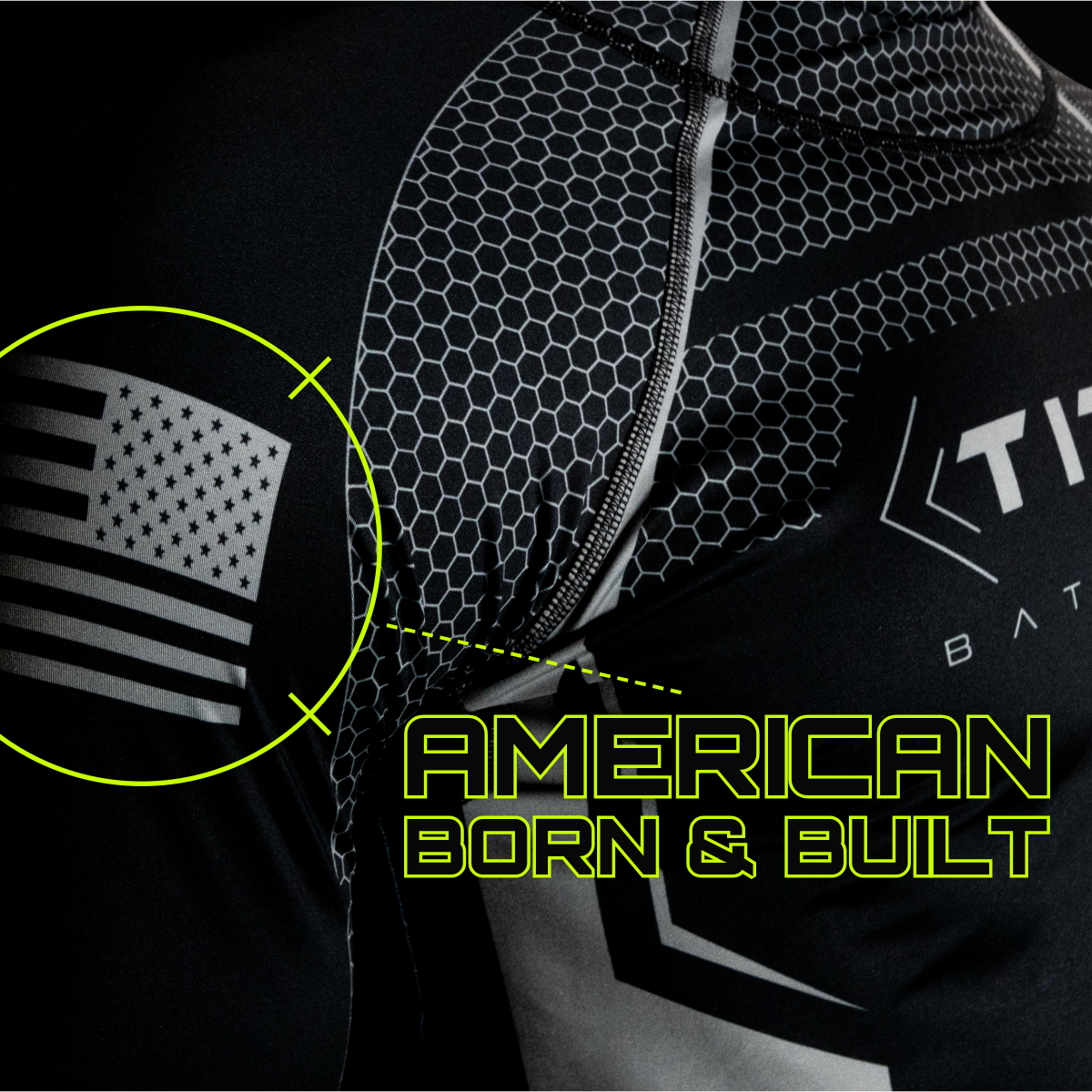 Close-up of a Titan Battlegear hockey neck guard shirt, showcasing the detailed hexagonal pattern and the Titan logo on the chest. The sleeve features an American flag design, emphasizing the shirt's craftsmanship and durability.
